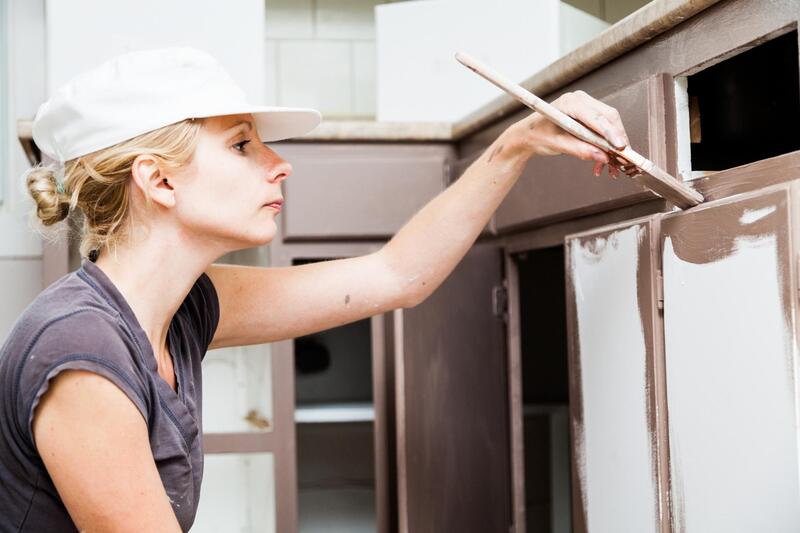 professional painter working at cabinets painting